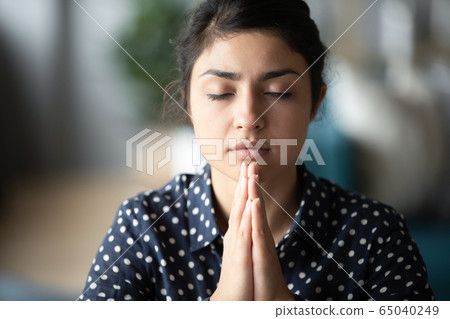 Hindu girl student folding hands, praying god for good luck. 65040249