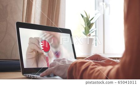 Doctor's advice on computer app, stethoscope with the Bahraini flag. Telehealth technology in Bahrain Doctor's advice on computer app, stethoscope with the Bahraini flag. Telehealth technology in Bahrain 65041011