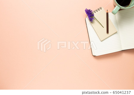 Work and study place. notebook and cup of coffee on pink background. flat lay, top view, copy space Work and study place. notebook and cup of coffee on pink background. flat lay, top view, copy space 65041237