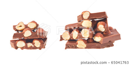 Hazelnut  and milk chocolate pieces tower isolated 65041763