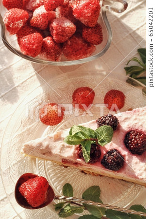 Fresh delicious dessert with berries and green decoration, sweet food, tea time, top view Fresh delicious dessert with berries and green decoration, sweet food, tea time, top view 65042201
