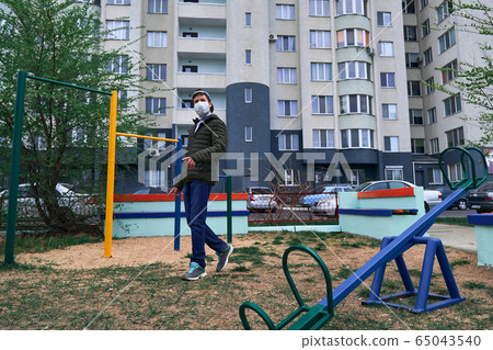 teen boy walks through the playground near 65043540