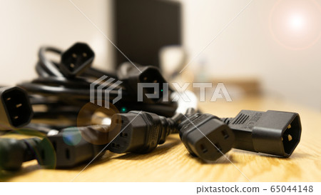 Black power cable of server on wooden table. Black power cable of server on wooden table. 65044148