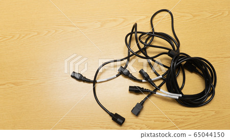 Black power cable of server on wooden table. Black power cable of server on wooden table. 65044150