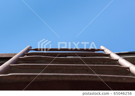 Red Staircase Rests Against Blue Sky. Development motivation Career Growth Concept 65046256