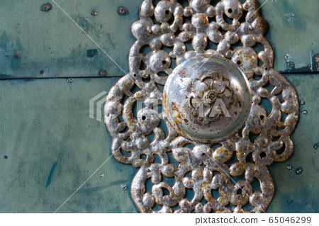 Decorative metallic handle on ironwork doors fittings, vintage light blue gate, azure color Decorative metallic handle on ironwork doors fittings, vintage light blue gate, azure color 65046299