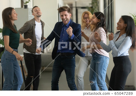 Happy young businessman mentor and woman dancing after successful deal. Happy young businessman mentor and woman dancing after successful deal. 65047289