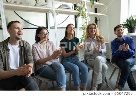 Diverse happy team applauding sitting at conference clapping hands. Diverse happy team applauding sitting at conference clapping hands. 65047293