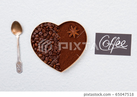 Coffee beans and instant coffee in a shape of heart. Coffee beans and instant coffee in a shape of heart. 65047518