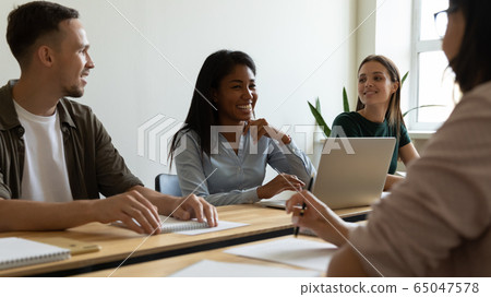 Young happy african american businesswoman laugh using laptop at briefing. 65047578