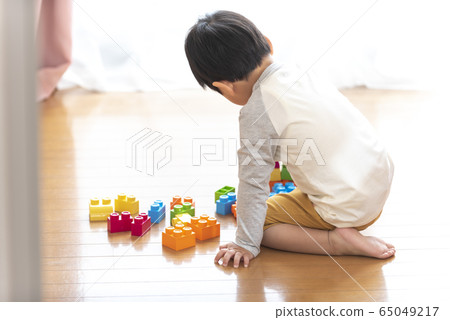 A boy playing with a block A boy playing with a block 65049217