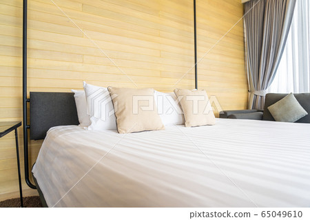 White comfortable pillow on bed decoration interior of bed room White comfortable pillow on bed decoration interior of bed room 65049610