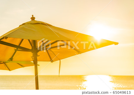 Beautiful tropical nature umbrella chair with palm tree around beach sea ocean at sunset or sunrise Beautiful tropical nature umbrella chair with palm tree around beach sea ocean at sunset or sunrise 65049613