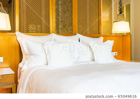 Comfortable white pillow on bed decoration in bedroom Comfortable white pillow on bed decoration in bedroom 65049616