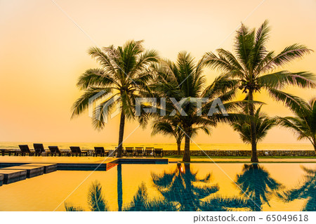 Beautiful nature with palm tree around outdoor swimming pool in hotel resort nearly sea ocean beach Beautiful nature with palm tree around outdoor swimming pool in hotel resort nearly sea ocean beach 65049618