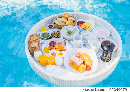 Floating breakfast set in tray with fried egg omelette sausage ham bread fruit milk juice coffee Floating breakfast set in tray with fried egg omelette sausage ham bread fruit milk juice coffee 65049679