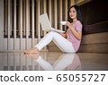 Portrait of Young asian woman sitting indoors in 65055727