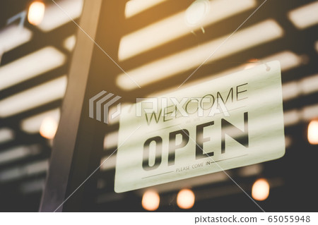 A business sign that says open on cafe or 65055948