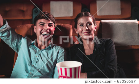 People audience watching movie in cinema theater. People audience watching movie in cinema theater. 65056587