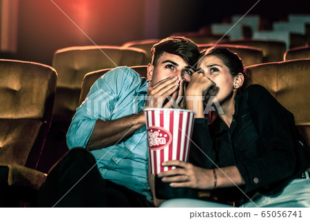 A couple lover watching movie in cinema theater. 65056741
