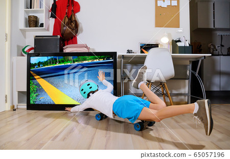 Boy imitating outdoor activities with skateboard Boy imitating outdoor activities with skateboard 65057196