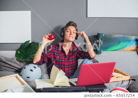 Woman working on computer remotely in bed Woman working on computer remotely in bed 65057254