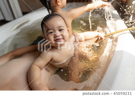 Asian happy laughing baby boy taking a bath 65059231