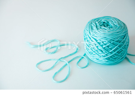 Knitting wool and knitting needles and yarn in pastel blue and aquamarine colors. top view. copy space. Close up. 65061561