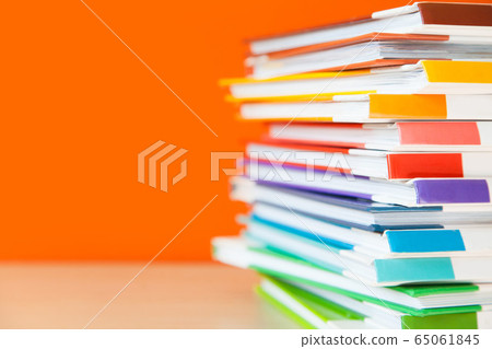 Stack of colorful books on color background. Stack of colorful books on color background. 65061845