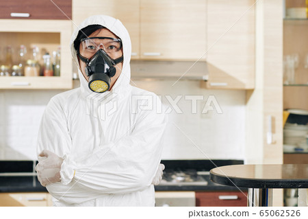 Serious technician in protective suit 65062526