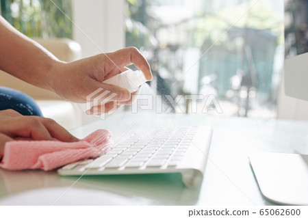 Office worker cleaning keyboard 65062600