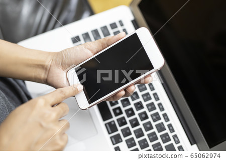 Working woman is working with a smart phone and 65062974