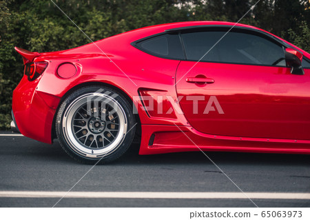 Modern red racing car commercial 65063973