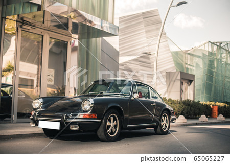Black vintage car in front of a luxury hotel 65065227
