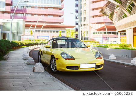 Yellow sport car in the metropolis streets 65065228