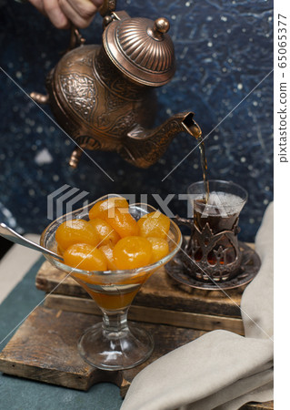 tea, teapot and apricot jam on the table tea, teapot and apricot jam on the table 65065377