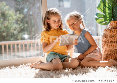 children are playing with tablet children are playing with tablet 65065457