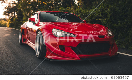 Red racing car on the highway with panoramic view in the autoshow Red racing car on the highway with panoramic view in the autoshow 65065467