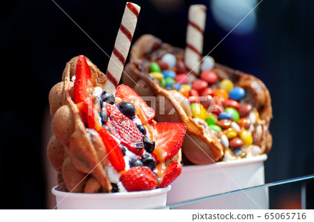 Delicious sweet bubble waffle on table Delicious sweet bubble waffle on table 65065716