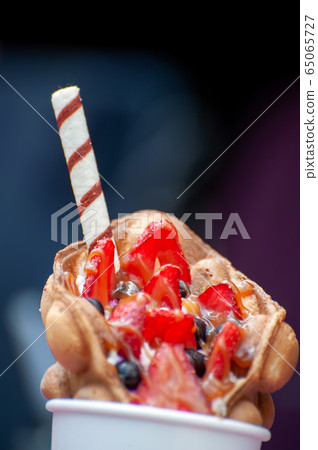 Delicious sweet bubble waffle on table Delicious sweet bubble waffle on table 65065727