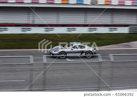 Silver sport car racing on the trace 65066392