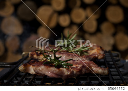 Pork Steaks With Rosemary Grilling on a Hot BBQ Pork Steaks With Rosemary Grilling on a Hot BBQ 65066552
