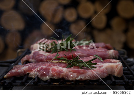 Pork Steaks With Rosemary Grilling on a Hot BBQ Pork Steaks With Rosemary Grilling on a Hot BBQ 65066562