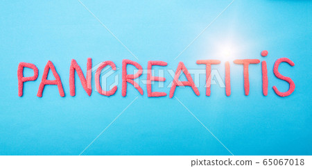 The word pancreatitis in red letters on a blue background. Pancreatic disease concept, epigastric pain and inflammation, medical 65067018