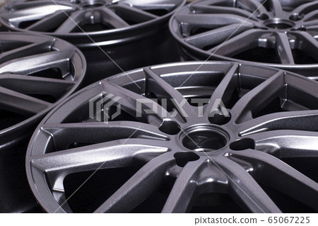 Modern automotive alloy wheel made of aluminum on a black background, industry. Designer fashion wheels for car 65067225