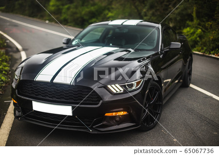 Black sport car with two white stripes on it Black sport car with two white stripes on it 65067736