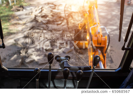 Hydraulic excavator control levers with bucket. Inside view, copy space, digger 65068567