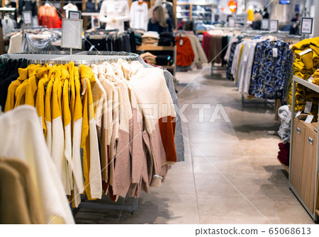 Selling and buying warm items in store for the autumn and winter season. Fashionable and stylish jackets and sweaters are sold in the store, fashionable 65068613