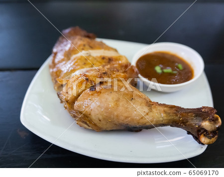 close up of fire chicken on the wood table close up of fire chicken on the wood table 65069170