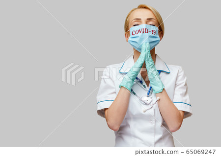 medical doctor nurse woman wearing protective mask and latex gloves - praying nad hoping gesture medical doctor nurse woman wearing protective mask and latex gloves - praying nad hoping gesture 65069247